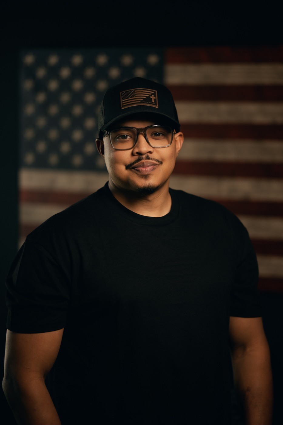Joshua Payne in front of an American flag